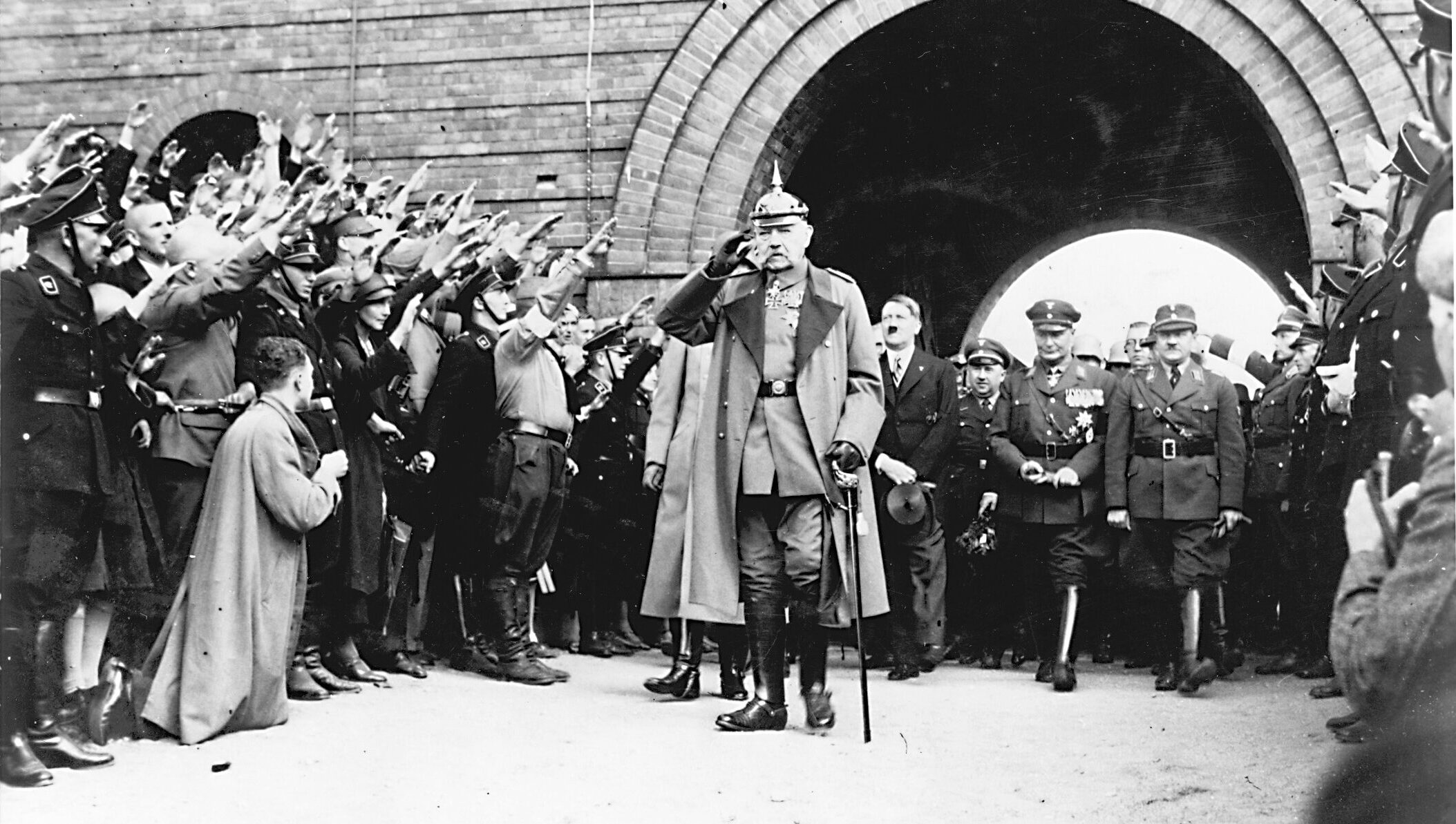 President Hindenburg accepting the salute of Nazi SS troopers as Hitler and Hermann Goering march behind.