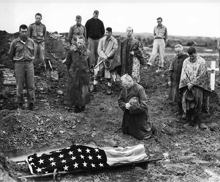 US Marine Colonel Francis Fenton conducting the funeral of his son Private First Class Mike Fenton, near Shuri, Okinawa, May 1945.