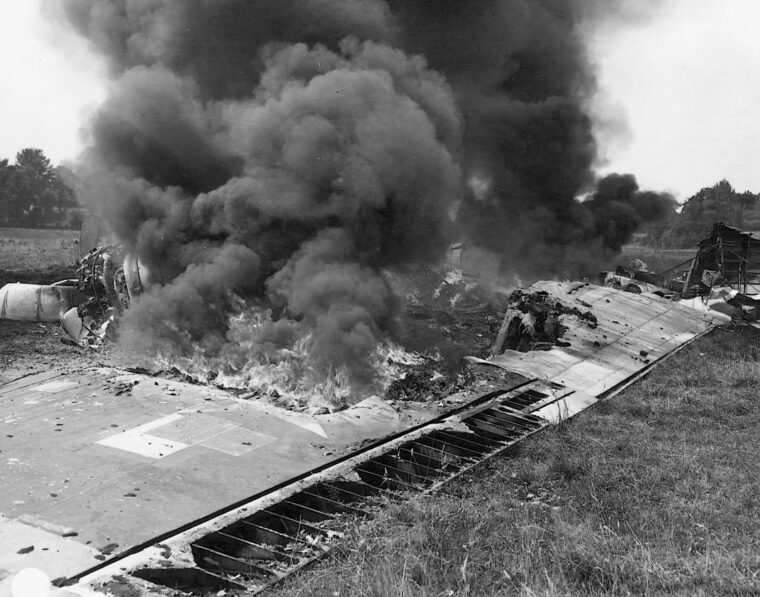 Thick sulphurous smoke pours from the flaming wreckage of a B-17 bomber in a French field.