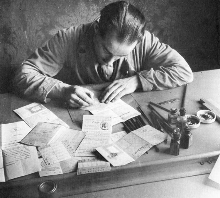 A Dutch Resistance member traces an official signature onto a forged identity document. These documents were instrumental in helping Allied escapees and escape-line workers pass police checkpoints.