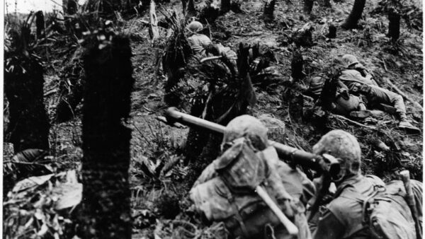 Marines inch their way up a battle-scarred hillside during heavy fighting on the southern end of Okinawa.