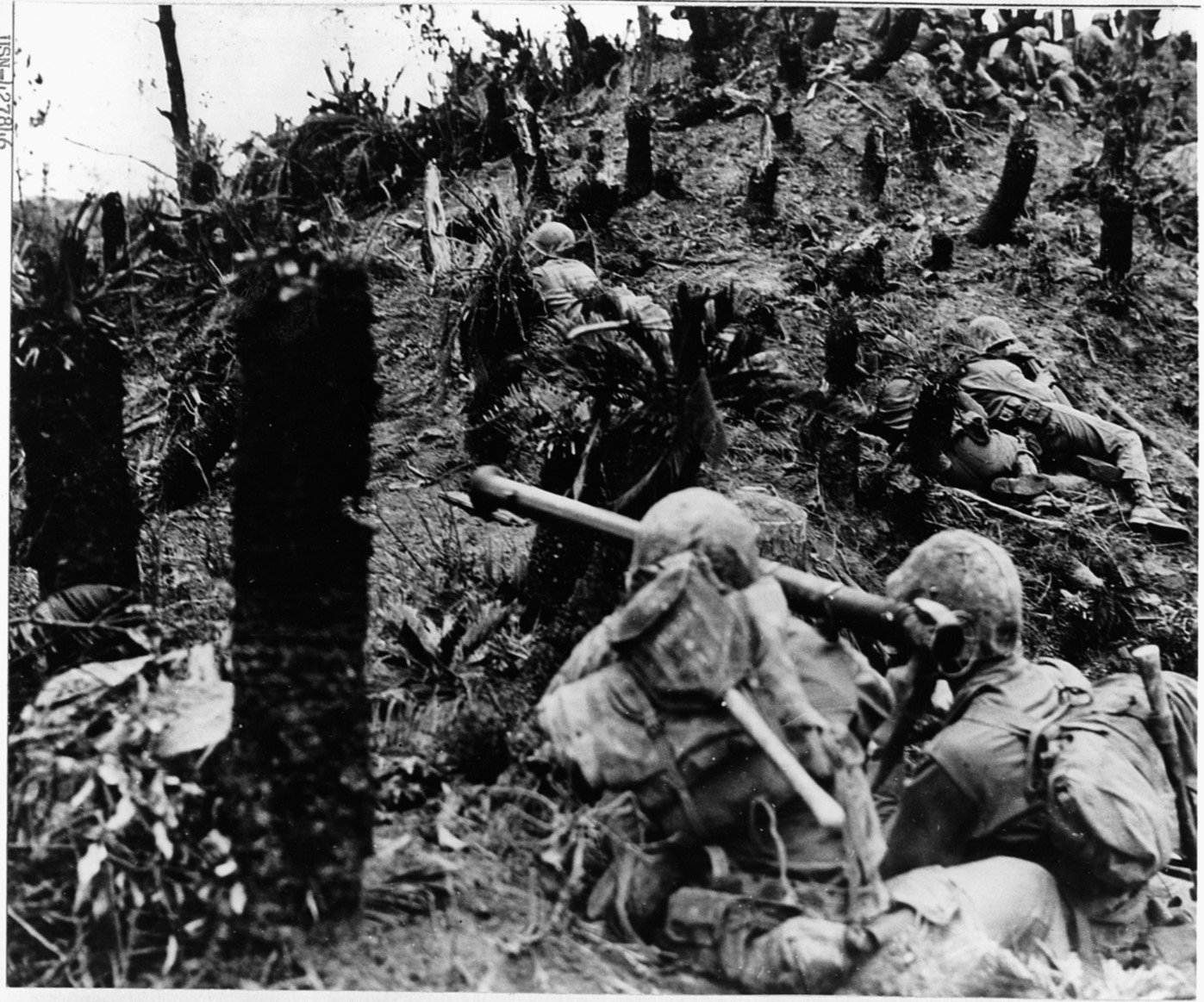 Marines inch their way up a battle-scarred hillside during heavy fighting on the southern end of Okinawa.