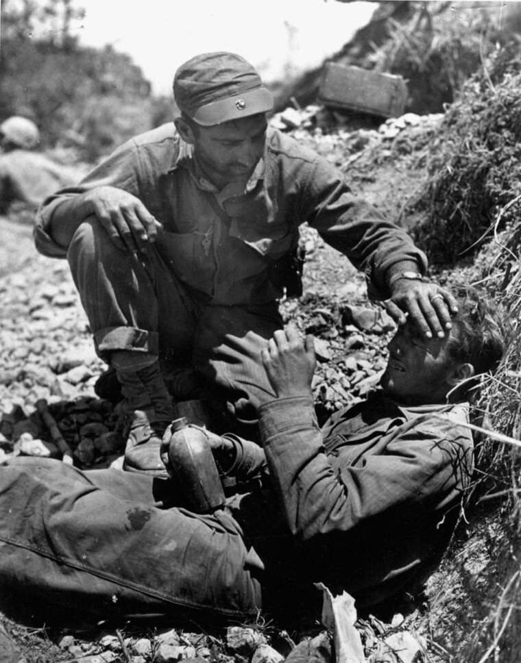A Marine takes time out to console a tearful comrade who has just lost a friend.