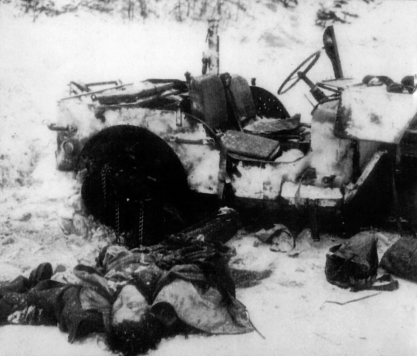 Dead German soldiers sprawl beside their jeep. Clothed in U.S. uniforms as part of Operation Greif, most of these volunteers paid with their lives.