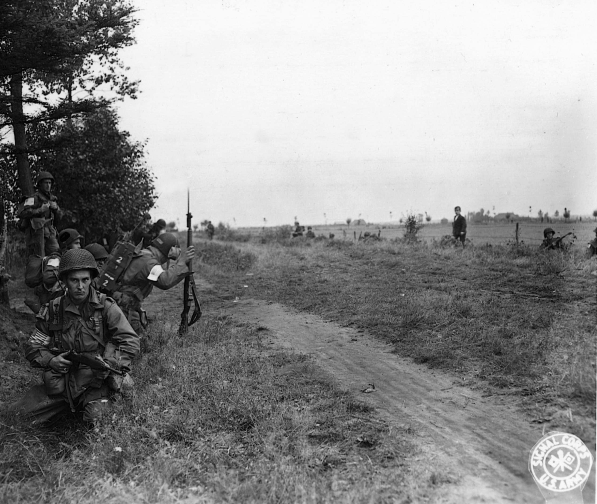Incoming artillery sends U.S. soldiers scurrying for cover along a roadside in Holland. The 101st Airborne Division jumped into Holland as part of Operation Market Garden in September 1944.