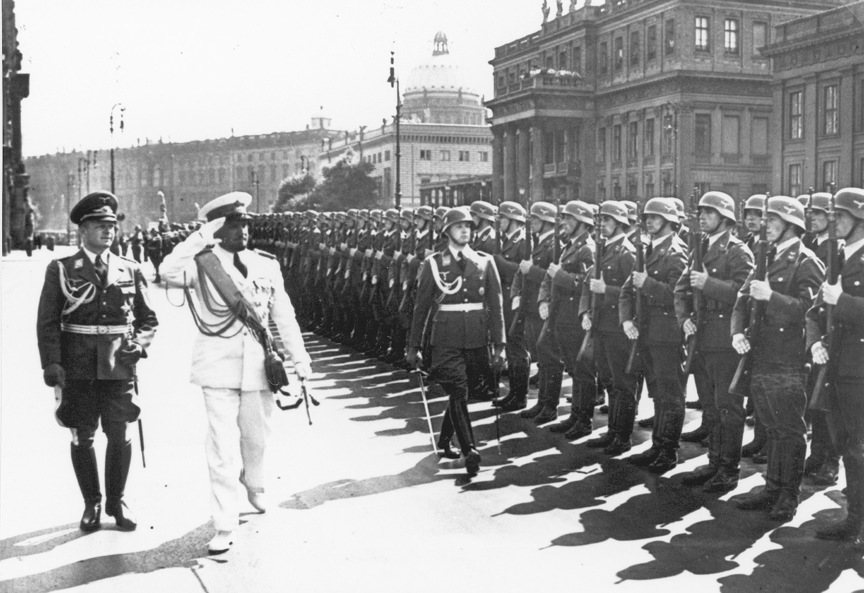 In August 1938, Balbo salutes as he reviews a Luftwaffe honor guard with General Erhard Milch in Berlin.