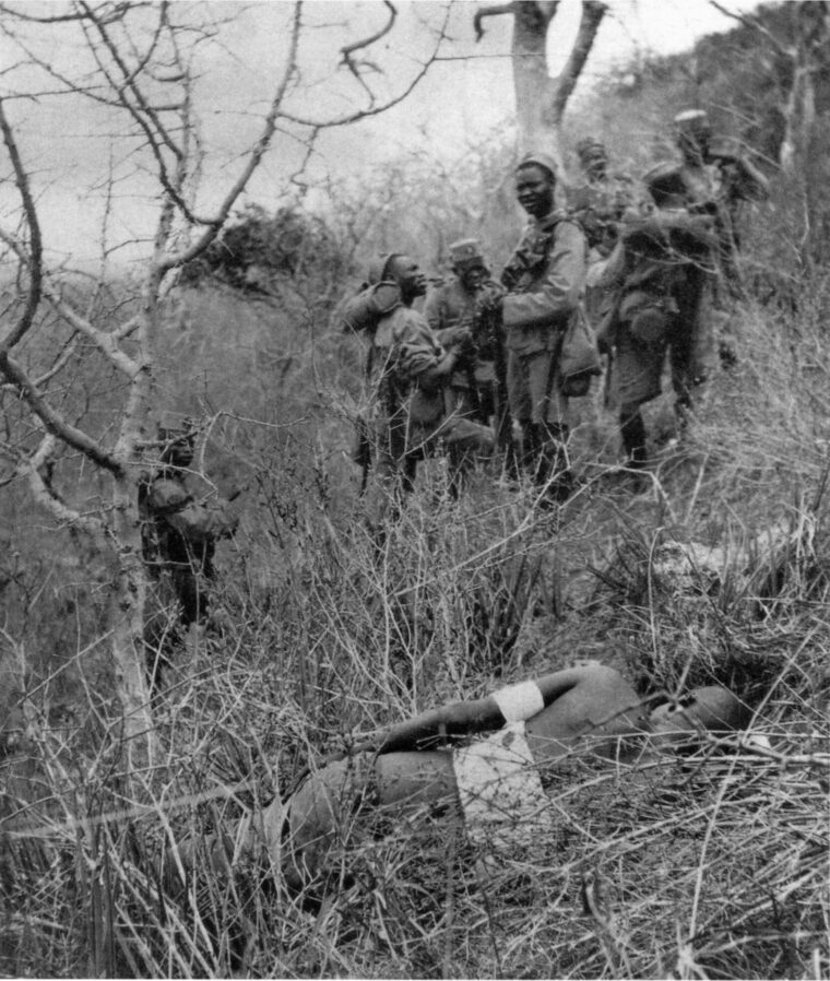 A patrol of 4th King’s African Rifles comes upon a wounded German Askari in the bush. 