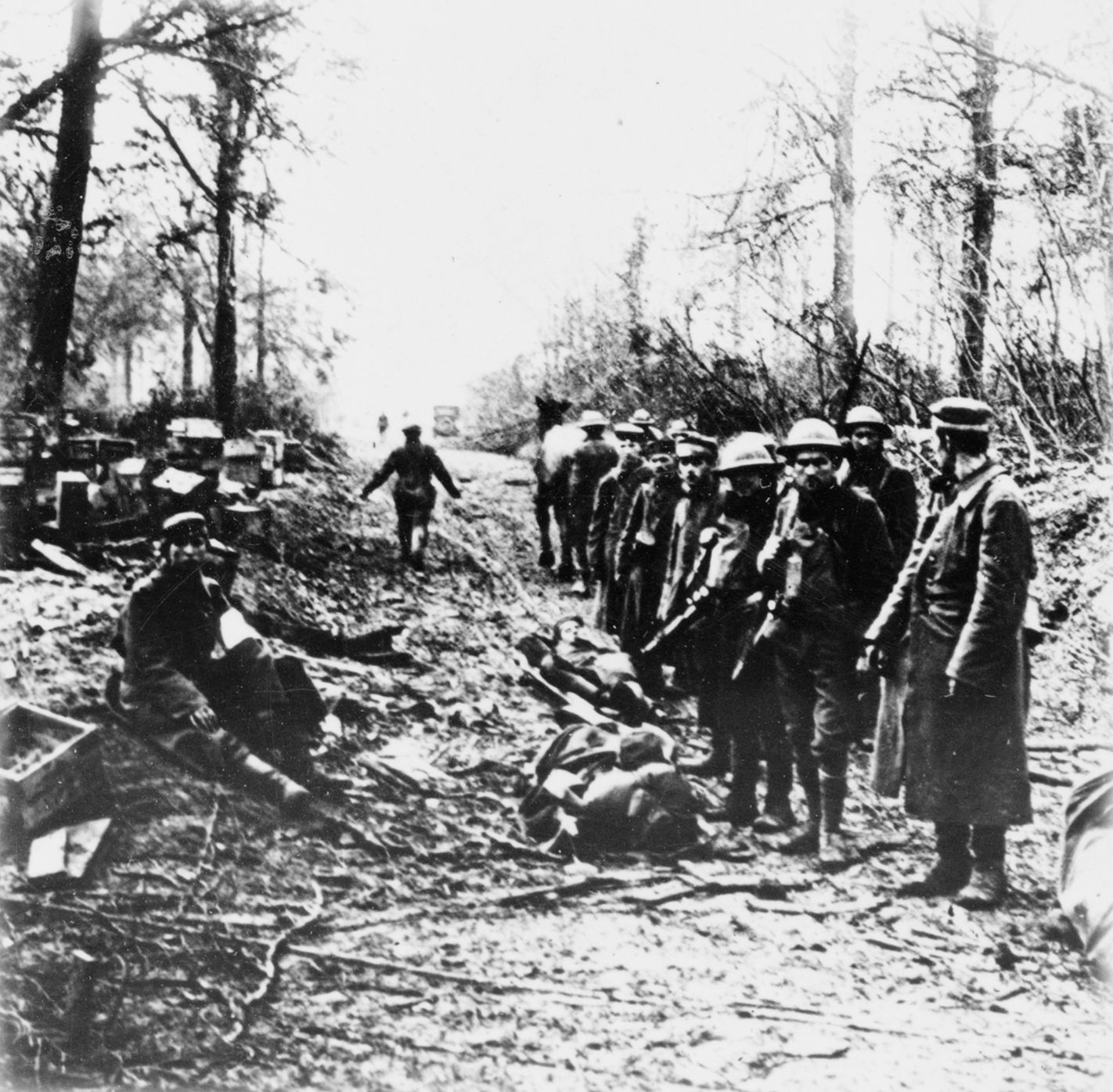 Grim-faced American soldiers guard German prisoners taken at Belleau Wood. 