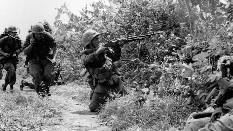 Marines of Company D, 3rd Platoon, rush to take defensive positions around Con Thien as they encounter heavy North Vietnamese gunfire.