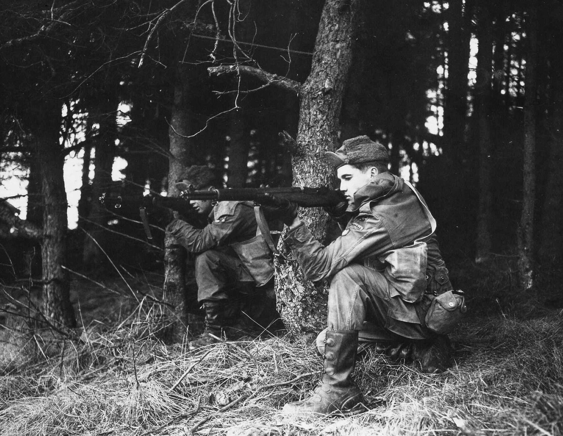 The King of Rock and Roll, Elvis Presley, pretends to fire his rifle during training exercises at Wildflecken, West Germany, in 1959.
