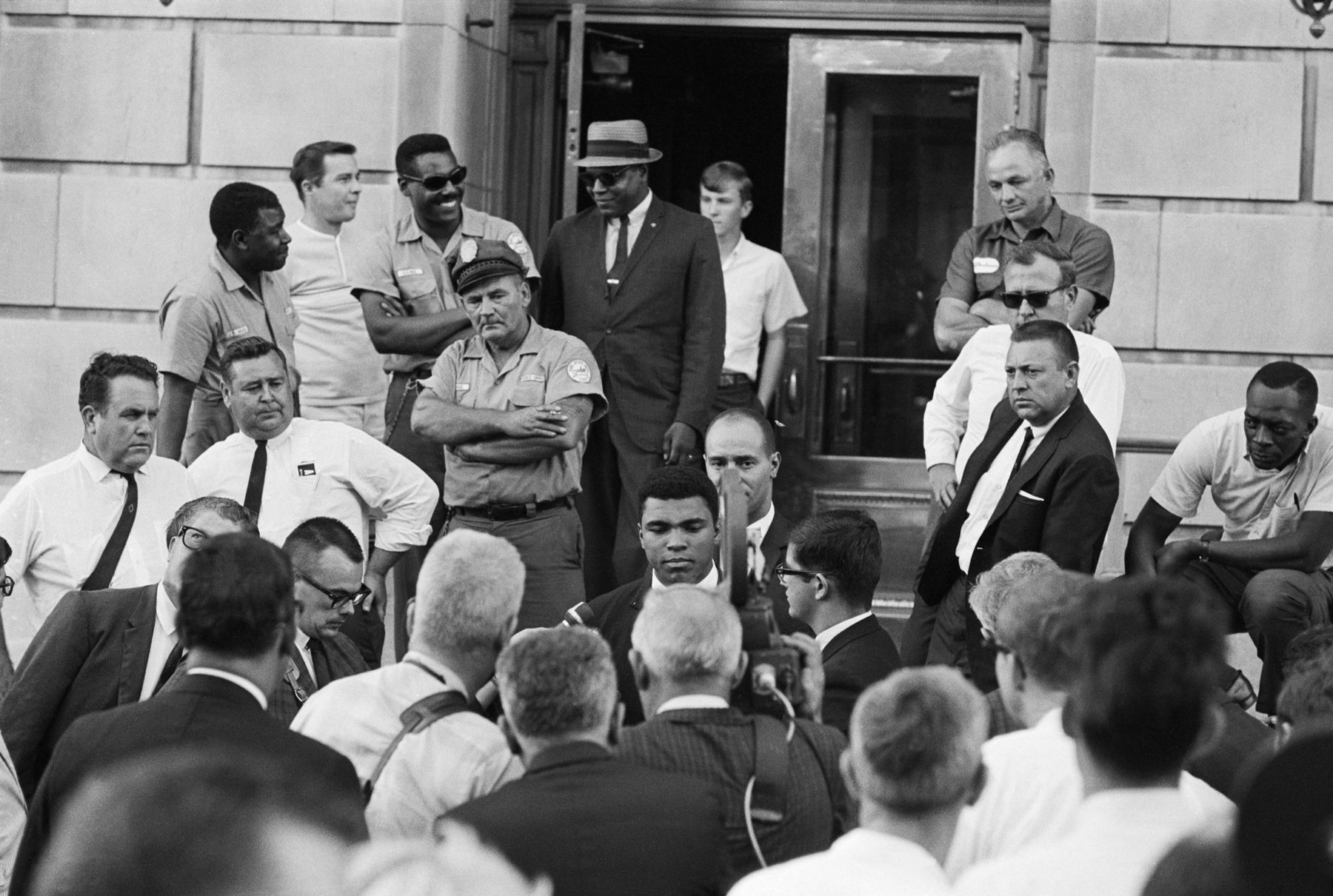 Heavyweight boxing champion Muhammad Ali holds an impromptu press conference in his hometown of Louisville, Kentucky, after refusing to take an induction oath.