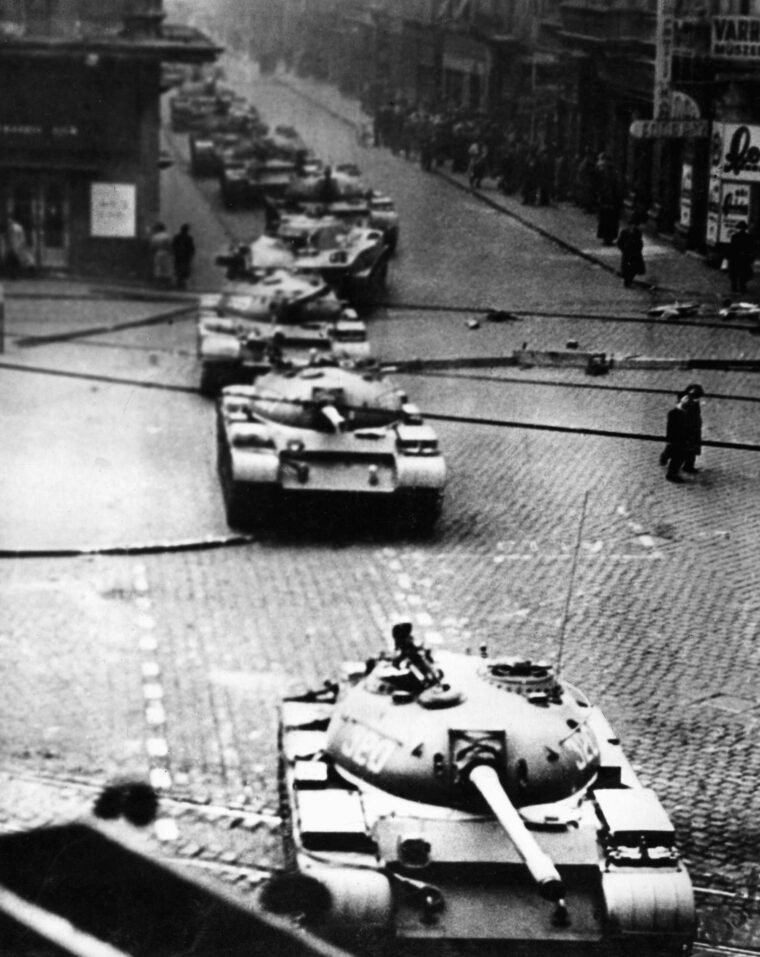A long, ominous line of Soviet tanks rumbles through an intersection in downtown Budapest during the height of the rebellion.