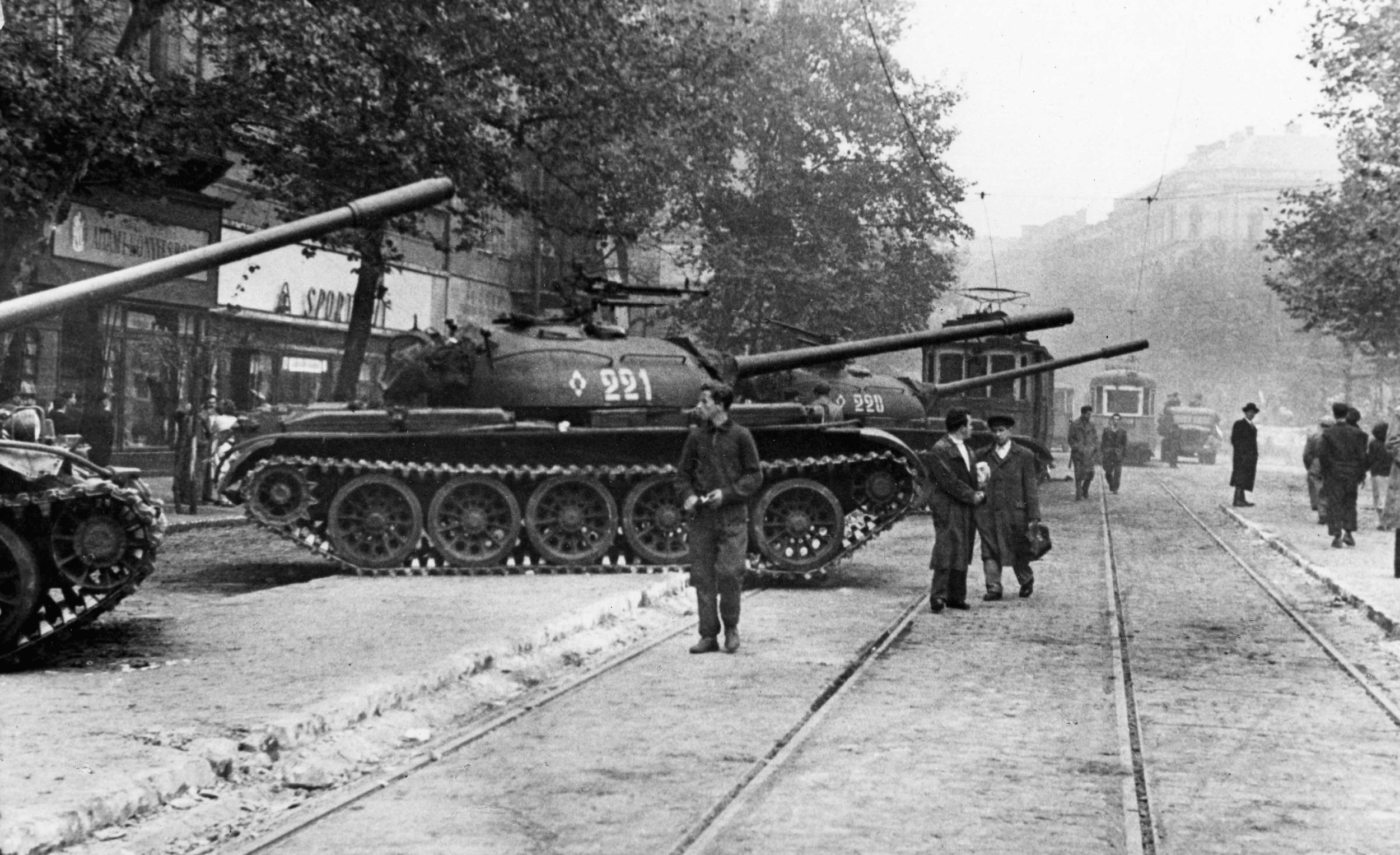 More Russian tanks stand ready for action in Budapest on October 30,  1956. Citizens look on warily.