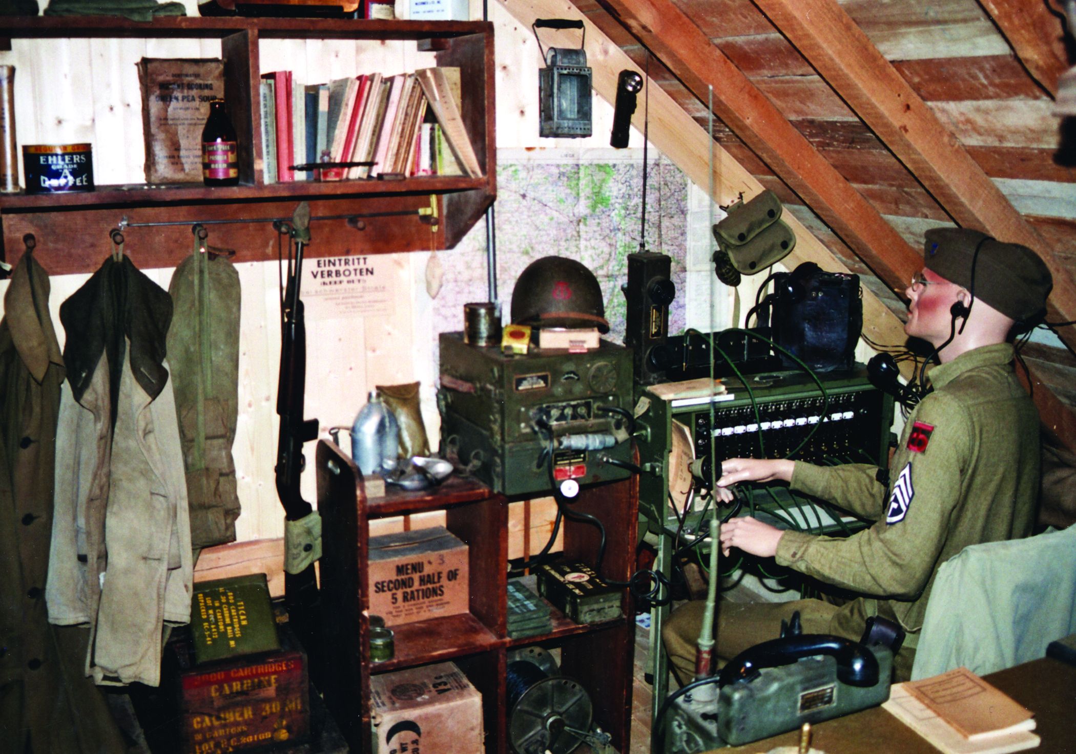 A mannequin wearing the uniform of a technical sergeant in the American 359th Infantry Regiment mans the equipment in the Hoffmann Museum’s “radio corner.”