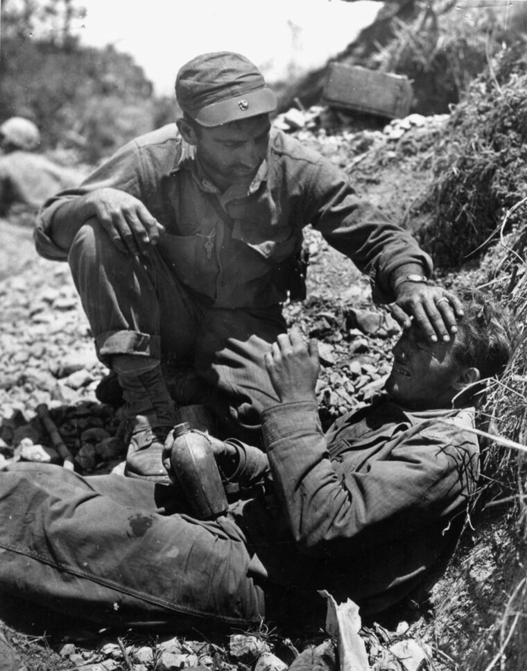 One Marine consoles another who has just lost a buddy in battle.