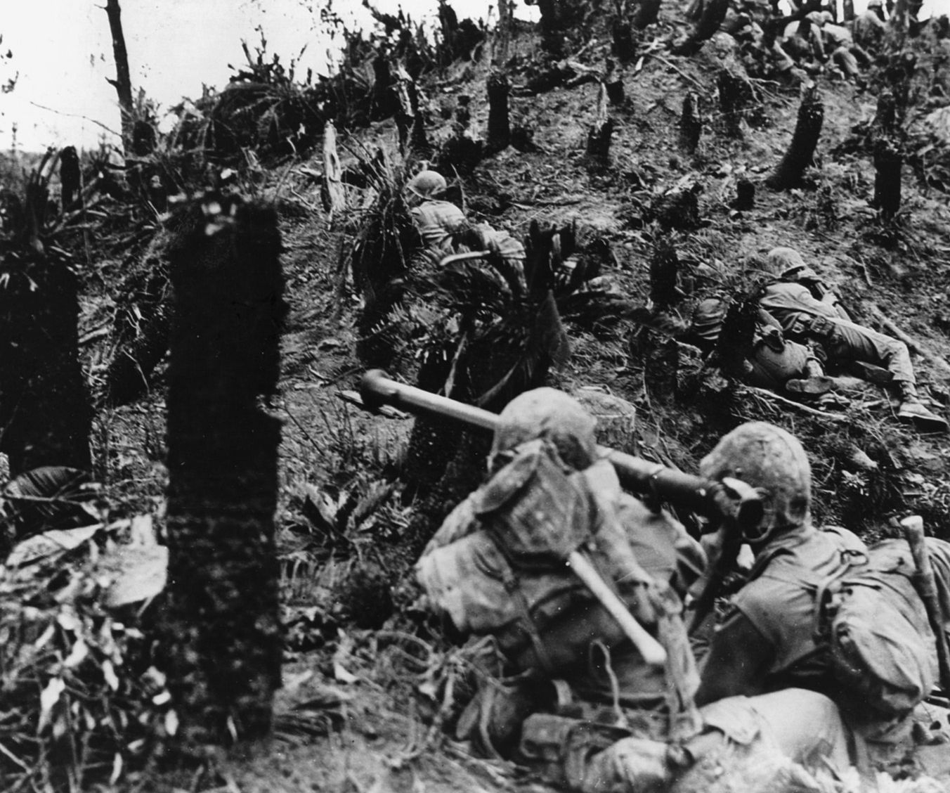 Marines inch their way up a battle-scarred hillside during the heavy fighting on the southern end of Okinawa.