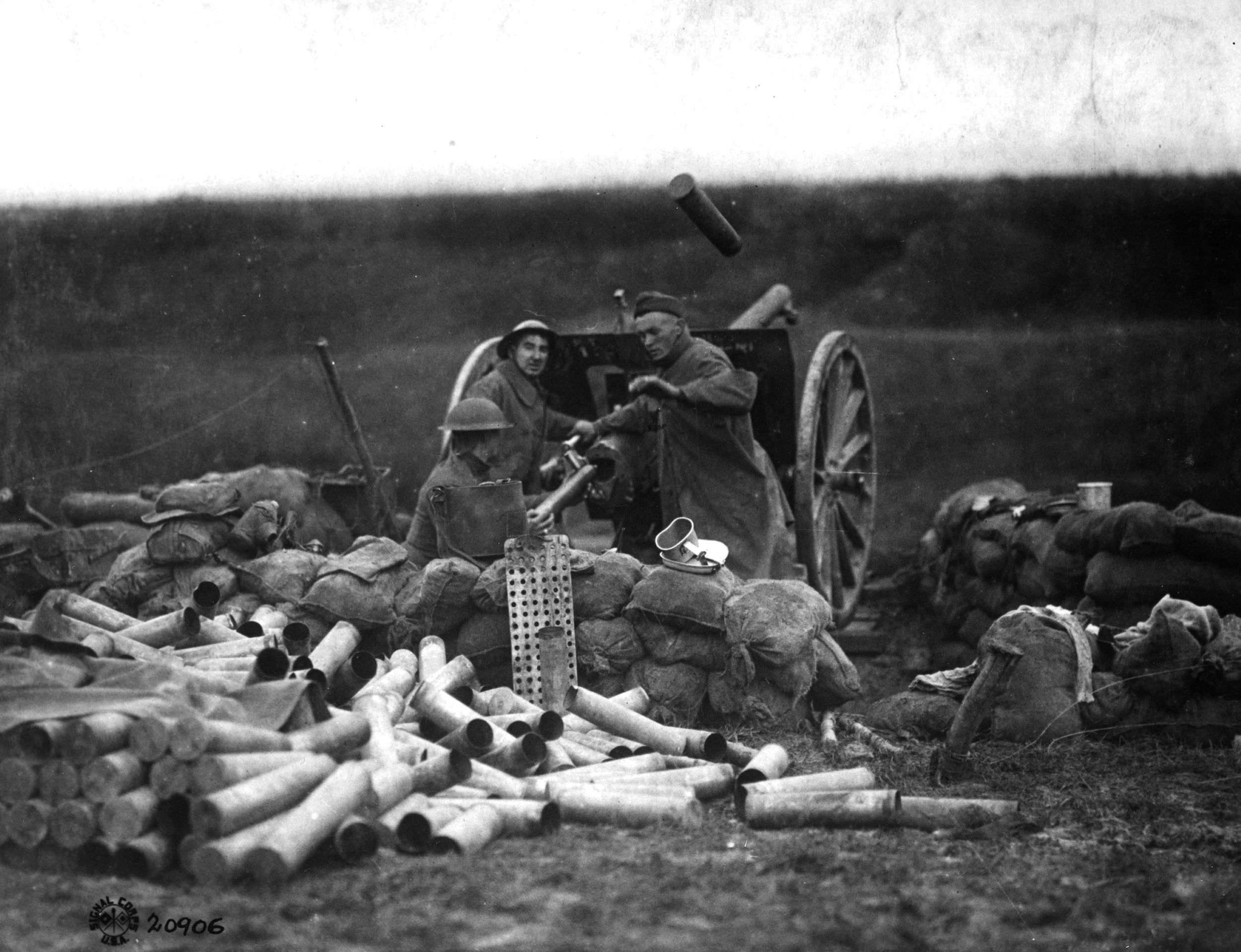 An American gun crew fires the 75mm at Saint-Michel, France, in September 1918. Note the large pile of expended shells and ammunition packing tubes behind the gun, indicating its high rate of fire. A shell casing is still in the air above the cannon.