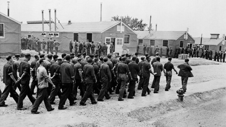 German POWs march to their barracks at a prison camp in the United States.