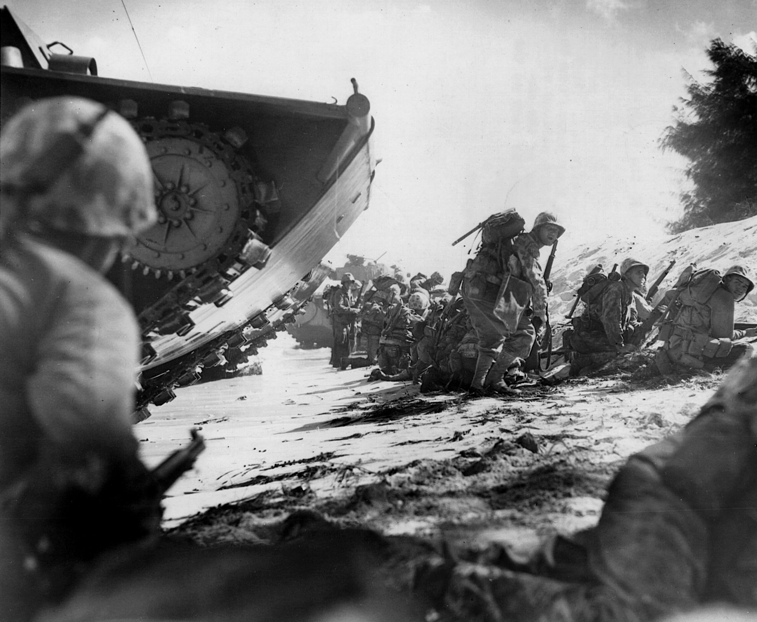 The first wave of Marines hits the beach at Saipan after disembarking their landing craft.