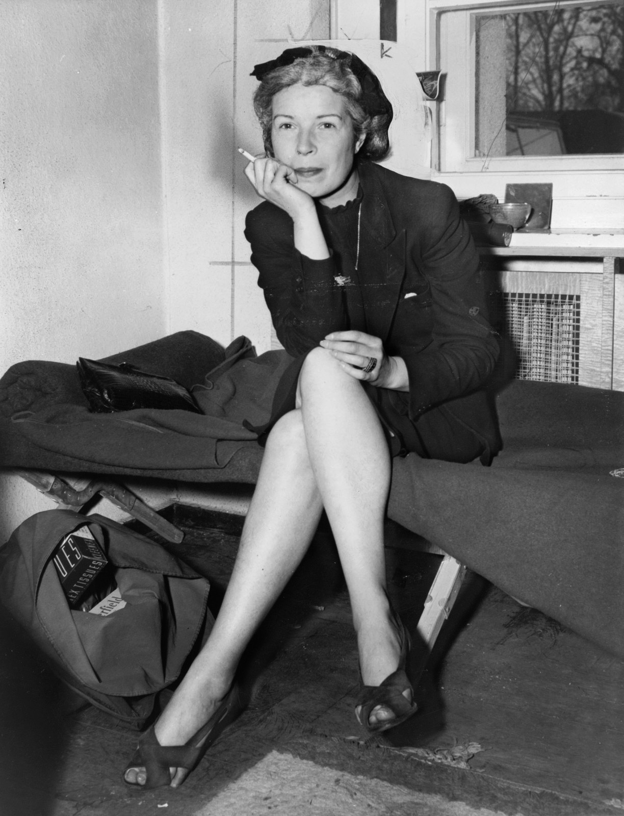Gillars smokes a cigarette as she talks to reporters at U.S. Counter-intelligence headquarters in Berlin, Germany, March 21, 1946.