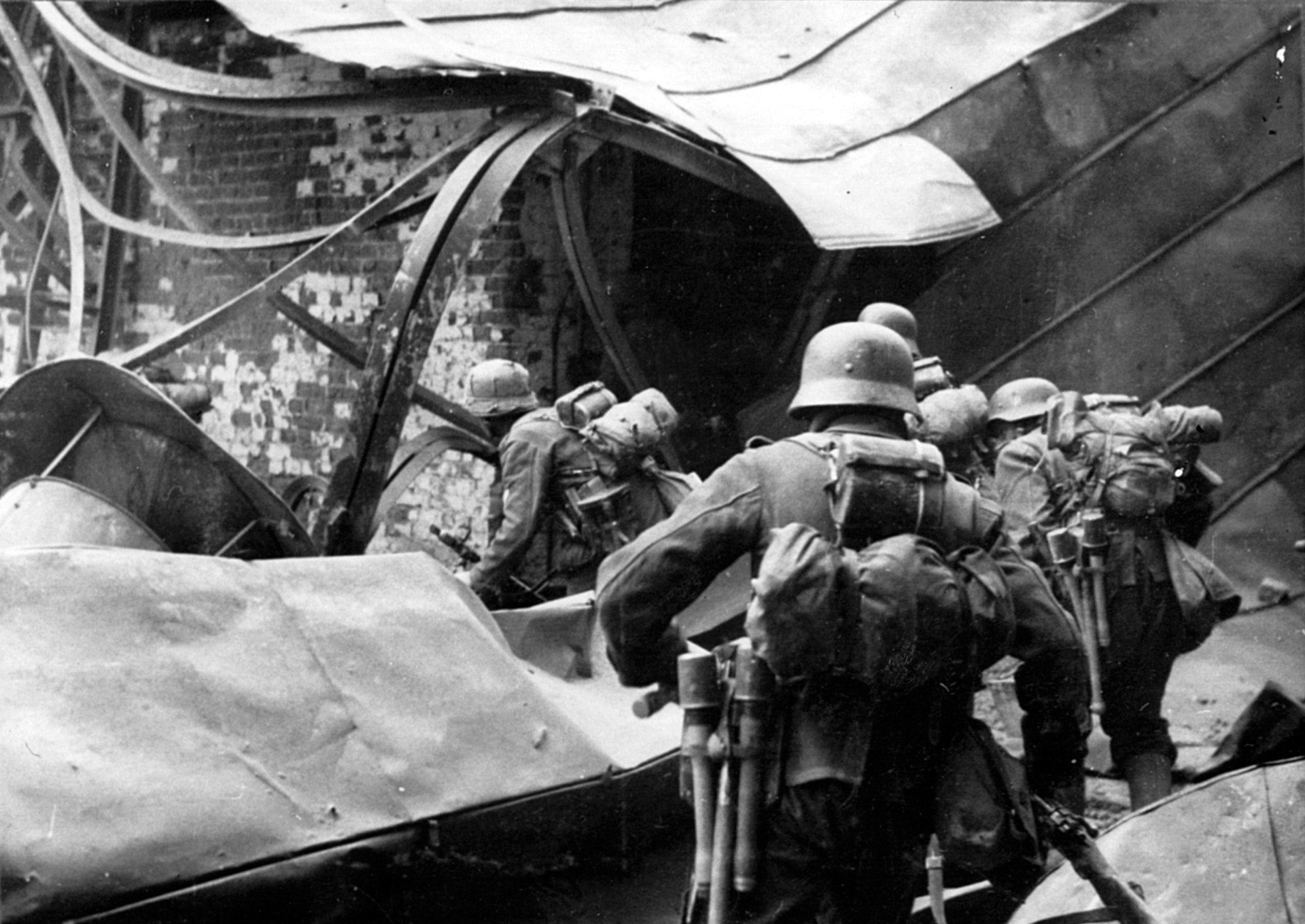 Exhausted by their protracted ordeal, German soldiers pick their way through the rubble of a demolished factory in Stalingrad.