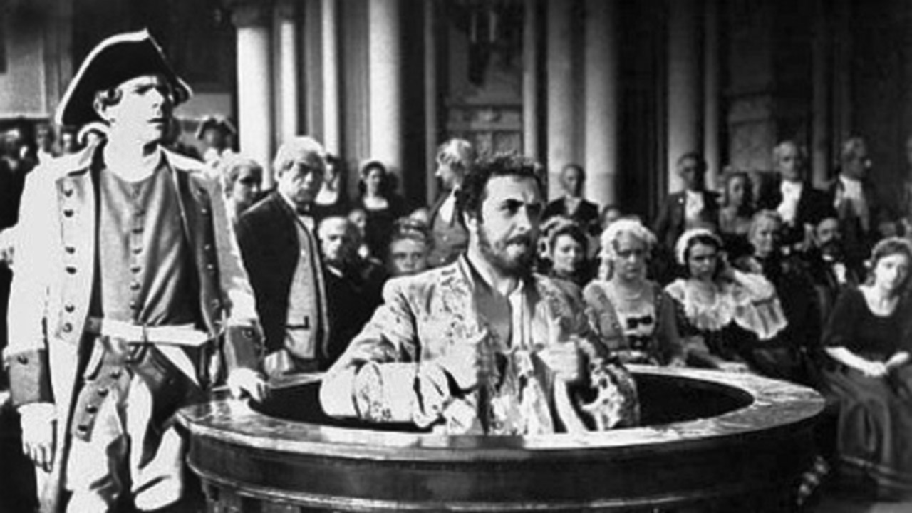 This still photograph from the film depicts the trial of the villainous Oppenheimer. The defendant was found guilty and publicly hanged, while other Jews were banished as a result of their supposed criminality.