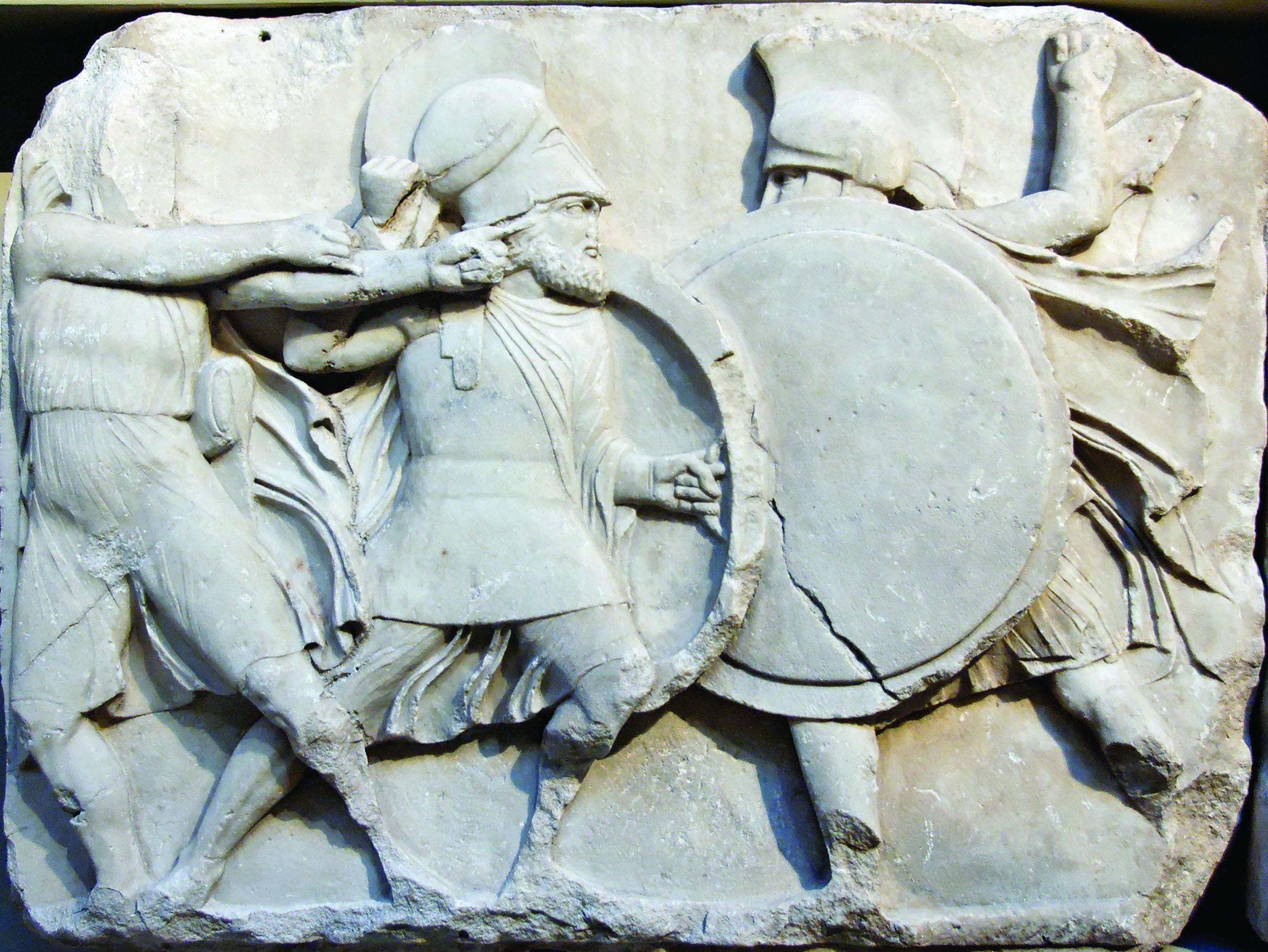 Two Greek warriors clash shields while an archer on the left unleashes an arrow. Shields were always carried on the left arm.
