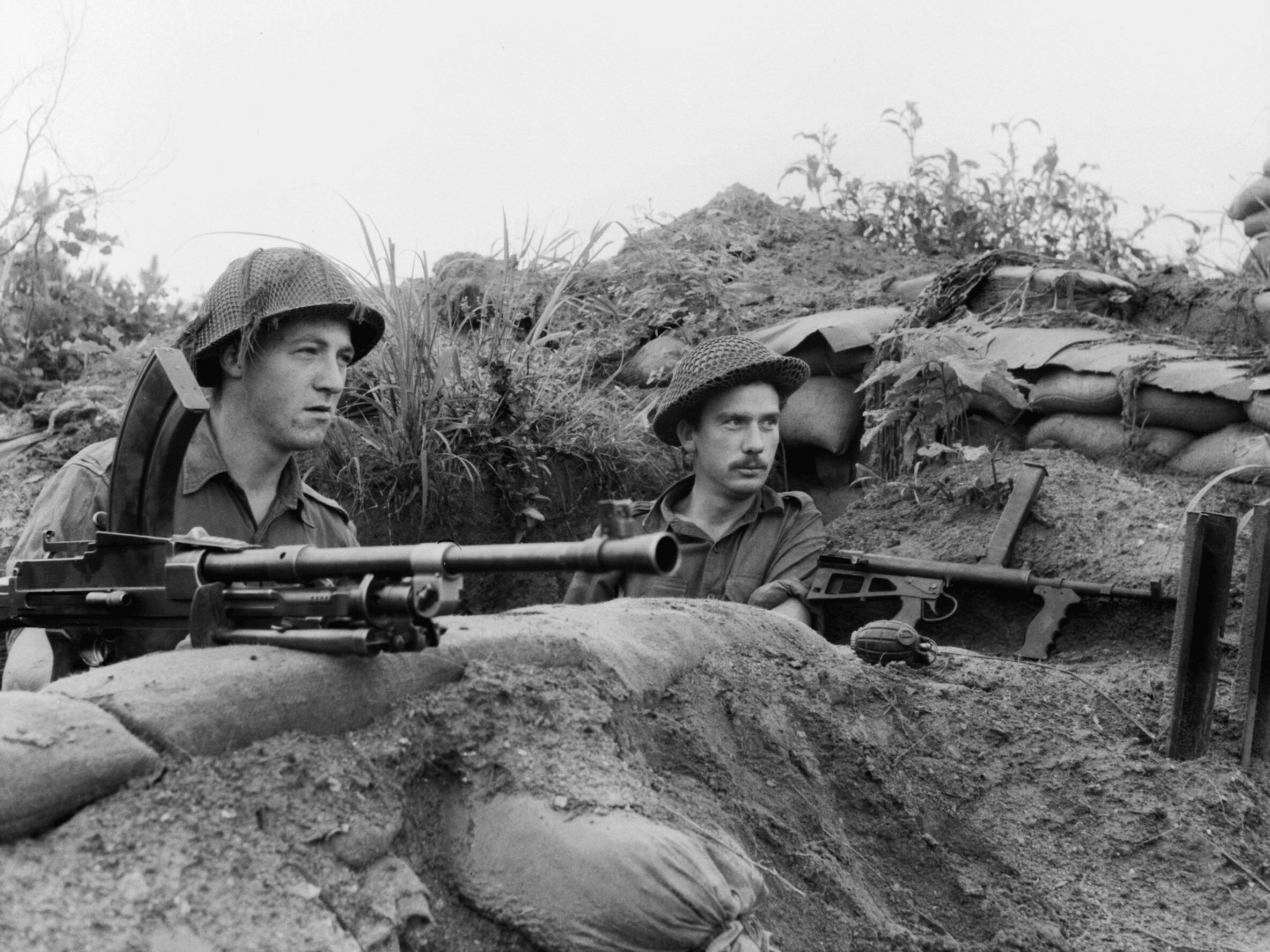 Private Peter Couch and Corporal Bill Laws of the 2nd Battalion, Royal Australian Regiment, look out at enemy lines in the Hook.