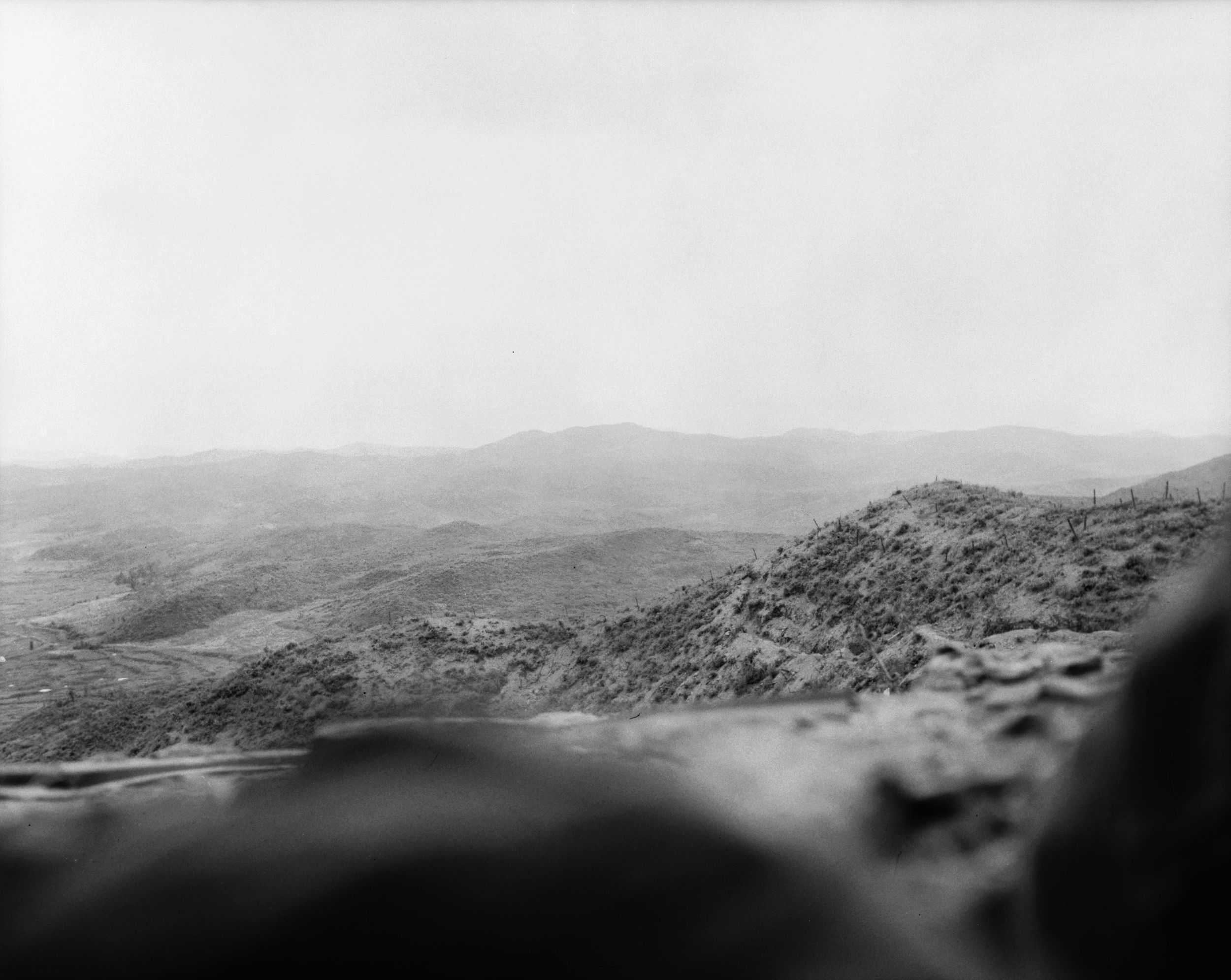Chinese positions in the Forward Platoon area of the Hook, looking due east. The grass-tufted ridge in the foreground is Ronson Run, which connected enemy positions in the Hook. 