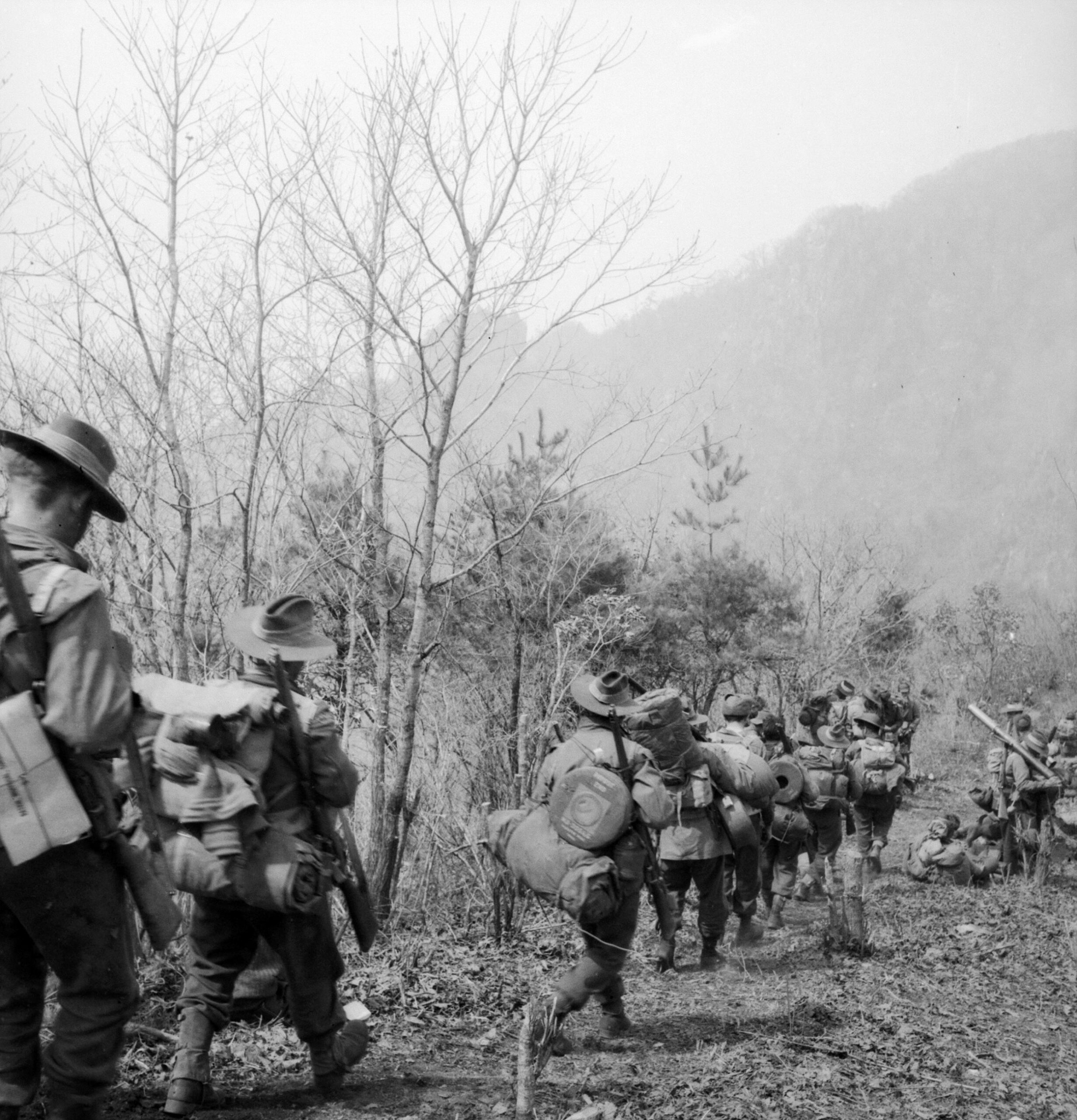 Loaded with gear, members of A Company, 3rd Battalion, Royal Australian Regiment prepare to counterattack the Chinese on Hill 504.