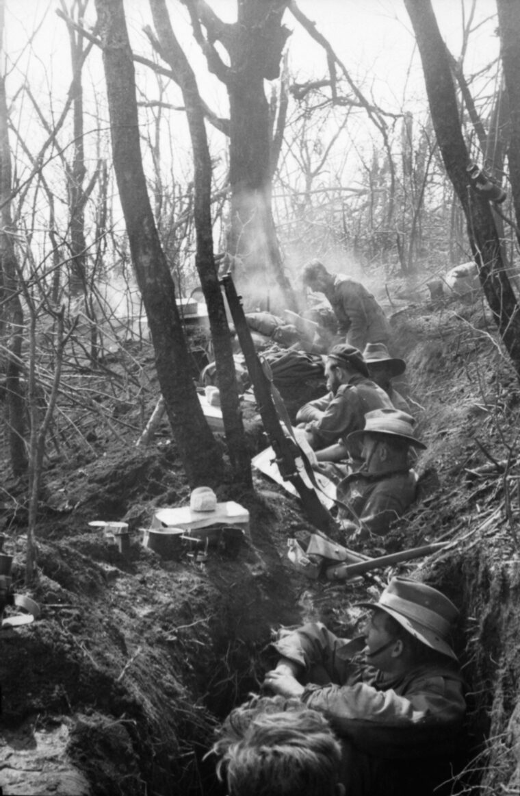 Members of the sniper section, 3rd RAR, man a shallow trench they had just captured from the Chinese at Hill Salmon. 