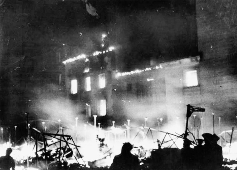 Franco’s forces prepare to launch their main assault on the Spanish capital of Madrid as a public market burns from incendiary bombs. 