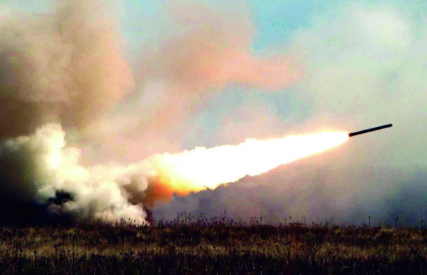 A High Mobility Artillery Rocket System fires a six-rocket volley of practice rounds at Fort Still, Oklahoma, in December 2003.