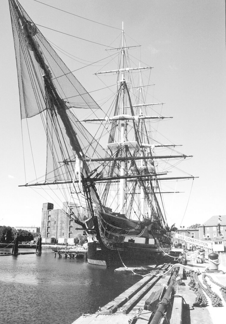 The USS Consti- tution in port at Boston Harbor. Sleek in design, smartly built,  she represents the origins of a great naval power. 