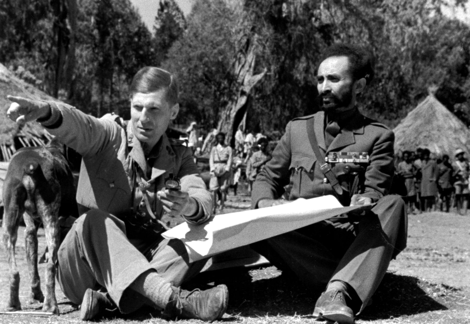 In a rare photo showing Colonel Orde Wingate (left) in full uniform and clean shaven, the British officer briefs Ethiopian Emperor Haile Selassie on the progress of the Abyssinian Campaign in 1941.