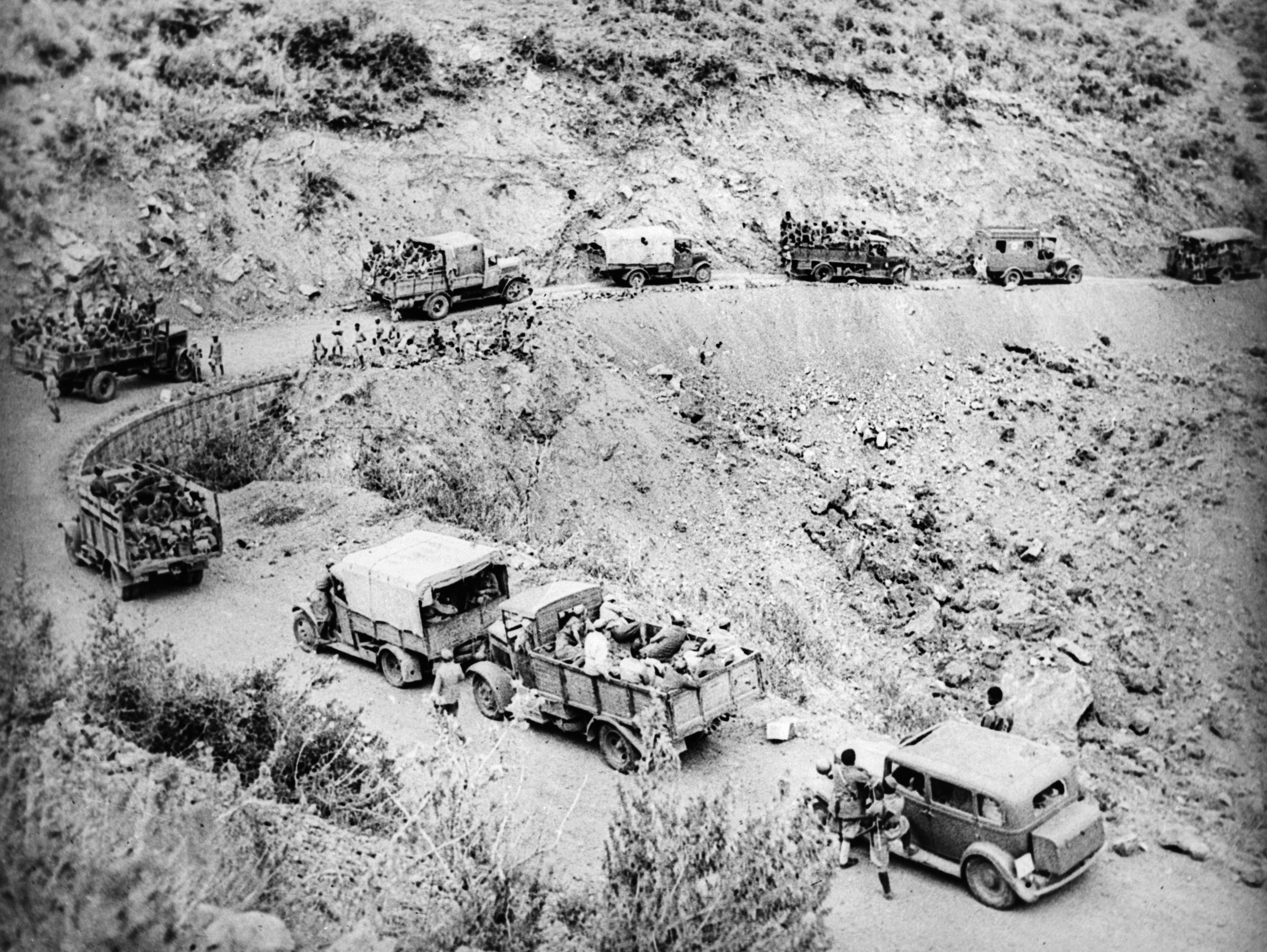 Aboard trucks descending a winding road in the rugged desert country of Ethiopia, South African soldiers move relentlessly forward in 1941. The South Africans were instrumental in achieving victory over the Italians.