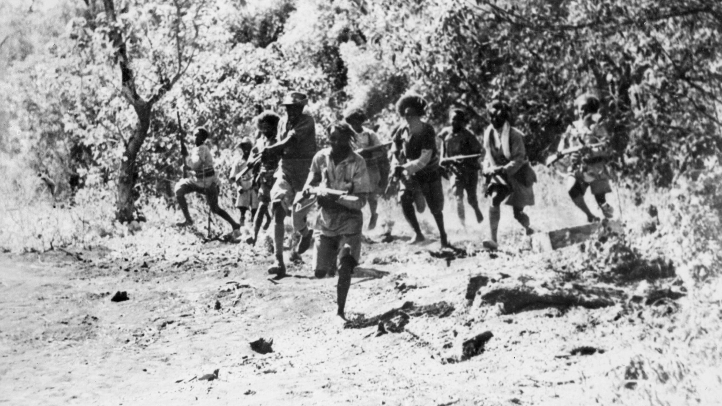Having been issued ammunition, Abyssinian troops known as Shifta advance on the run to take up positions against the advancing enemy.