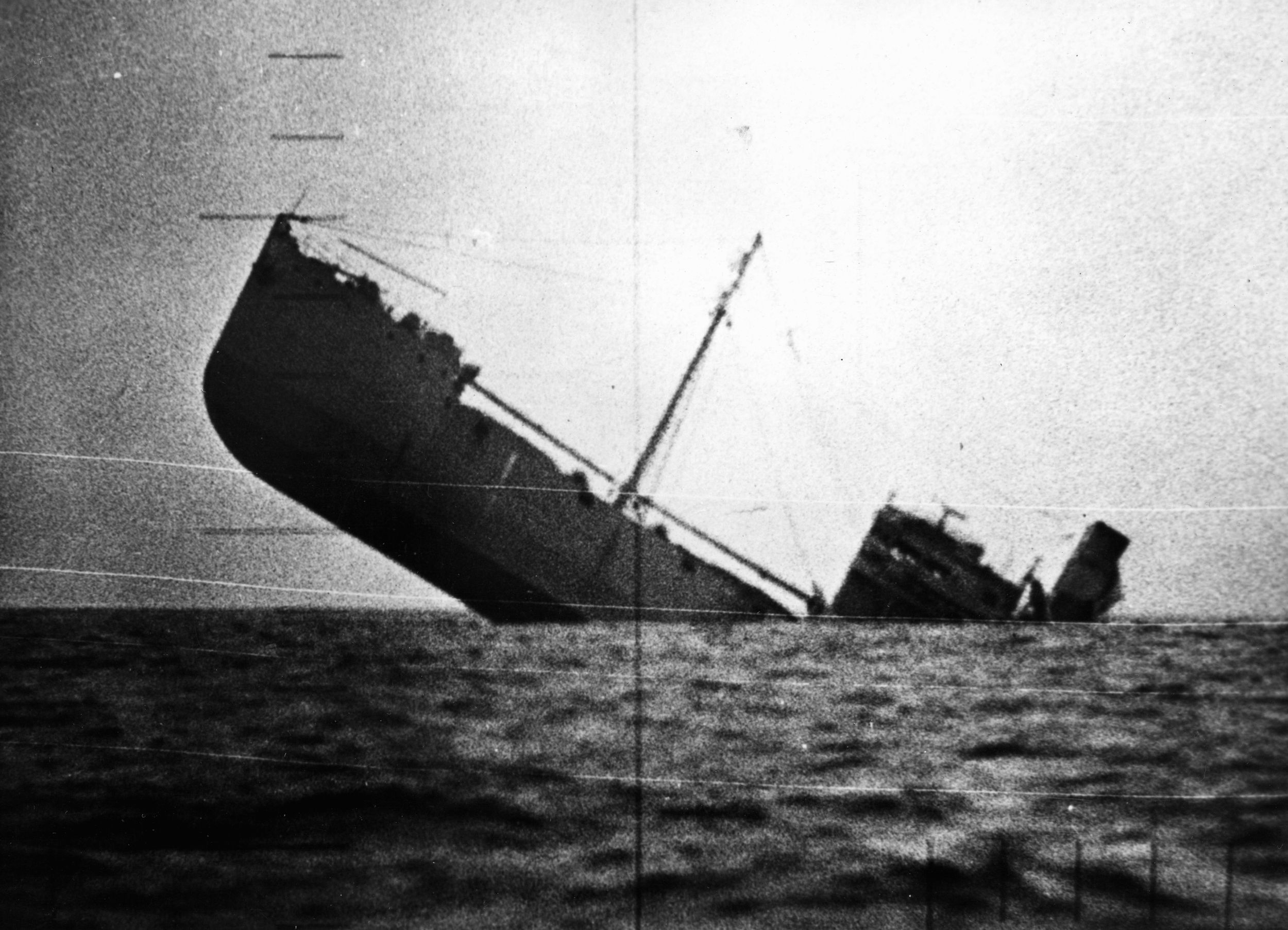 A photo taken through the periscope of an American submarine shows a Japanese merchant ship in its death throes. This sinking was the 1,142nd such loss for the Japanese of the war since the bombing of Pearl Harbor on December 7, 1941. 