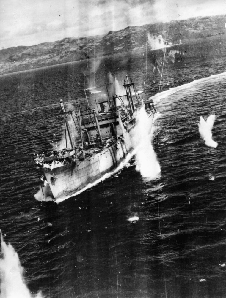 Part of a convoy en route to resupply and reinforce the airfield and garrison at Ormoc on the Philippine island of Leyte, this Japanese freighter is under attack by B-25 Mitchell medium bombers of the U.S. Far East Air Force.  Men are seen scrambling for cover as machine gun bullets rip through decking and bombs fall close by. During this action in April 1945, the Americans sank at least three transports and six escort vessels, while damaging several others. 