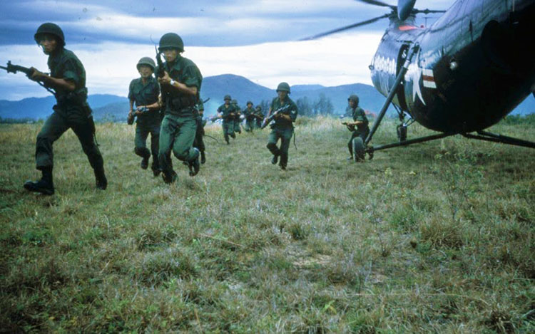 Dickey Chapelle photographed South Vietnamese (ARVN) soldiers advance on a village suspected of harboring Viet Cong near Soc Tranh, during the Vietnam War. (Wisconsin Historical Society)