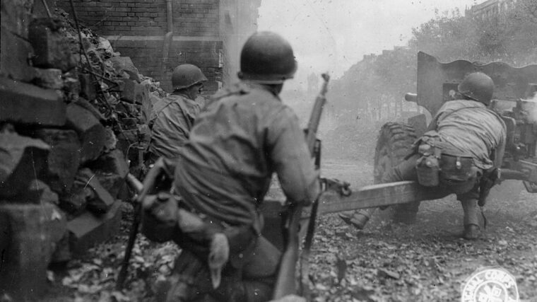 In the close quarters of a rubble-strewn street in Aachen, American soldiers fire a 57mm antitank weapon against a distant German target. Urban warfare became a new concept for Allied armies, and they adapted during the advance into Germany. (National Archives)