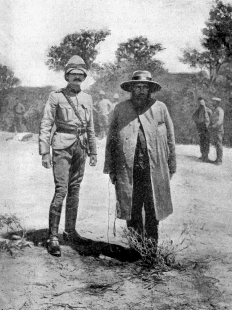Boer General Piet Cronje stands with Lord Roberts’ ADC after surrendering at Paardeberg.
