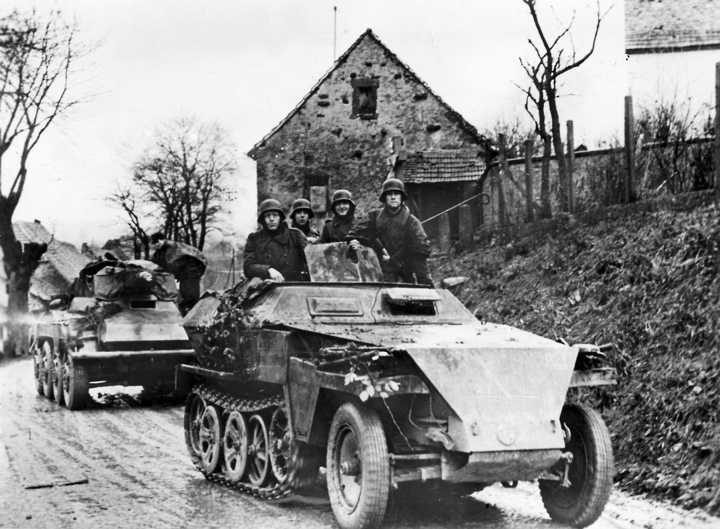 In October 1944, a German Schutzenpanzer half-track moves toward the fighting on the Western Front in company with a light tank. The German defense of Aachen, once the capital of the Holy Roman Empire, was tenacious. (ullstein bild)