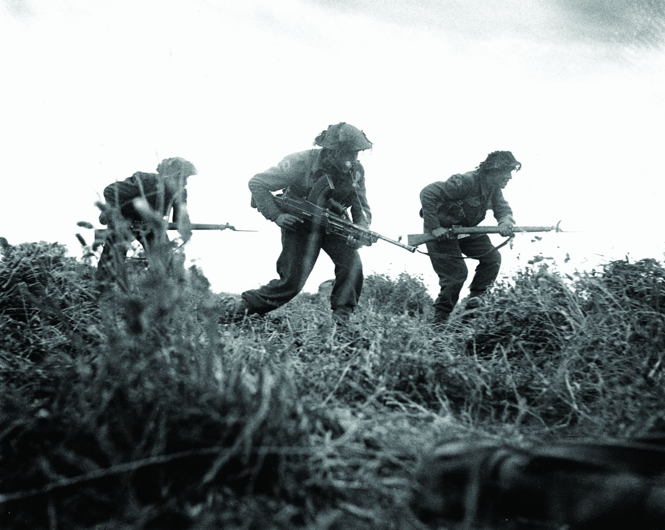Three British infantrymen advance cautiously during a probe of German positions around the villages of Baron and Eterville southwest of Caen. Although the capture of Caen was an objective to be gained on D-Day, the city did not fall to the Allies until a month later.