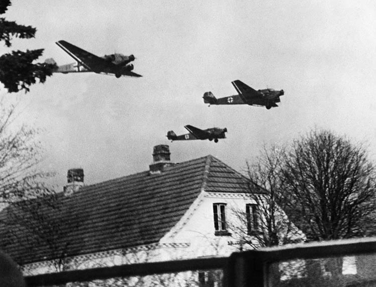 On April 10, 1940, German Junkers Ju-52 transport aircraft, laden with troops and supplies, fly above a Danish village. German aircraft losses were high during the invasion of Denmark and Norway.