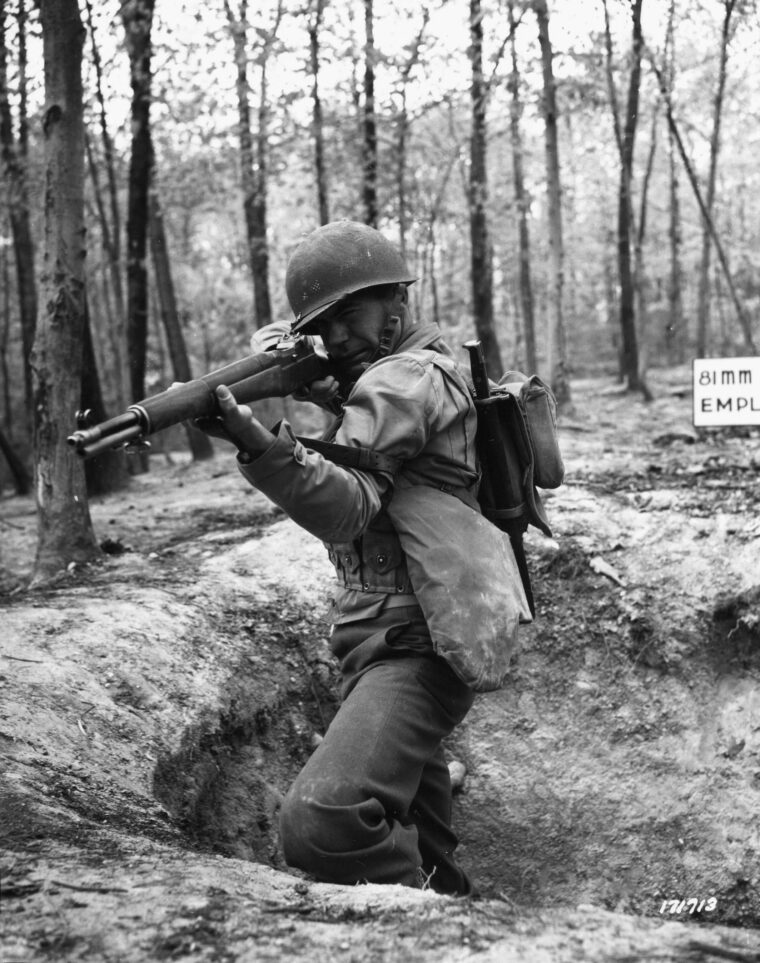 A U.S. soldier aims his M-1 Garand rifle during training exercises. During World War II, the M-1 was the standard-issue combat rifle for American troops.