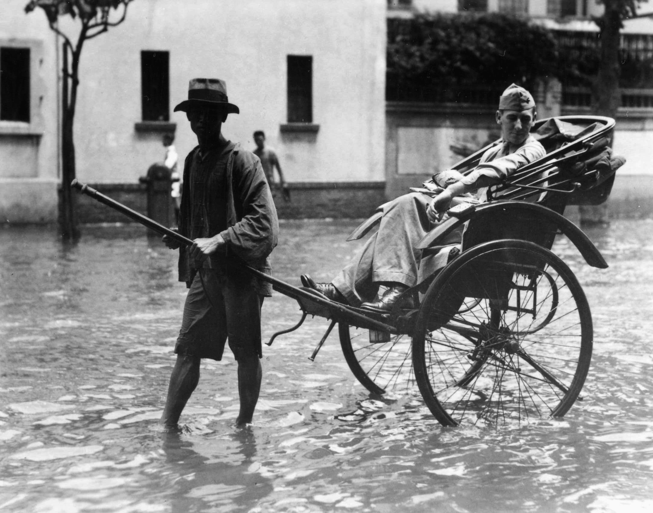 High and dry for the moment, a U.S. Marine rides through floodwaters along a street in Shanghai sometime in 1937. The Americans were part of an international force sent to protect foreign nationals during perilous times on the Asian mainland. (National Archives)