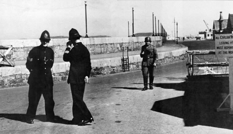 The island of Guernsey is oddly patrolled by two British bobbies and a German sentry. The Channel Islands were the only British territory to endure occupation by the Nazis during World War II.