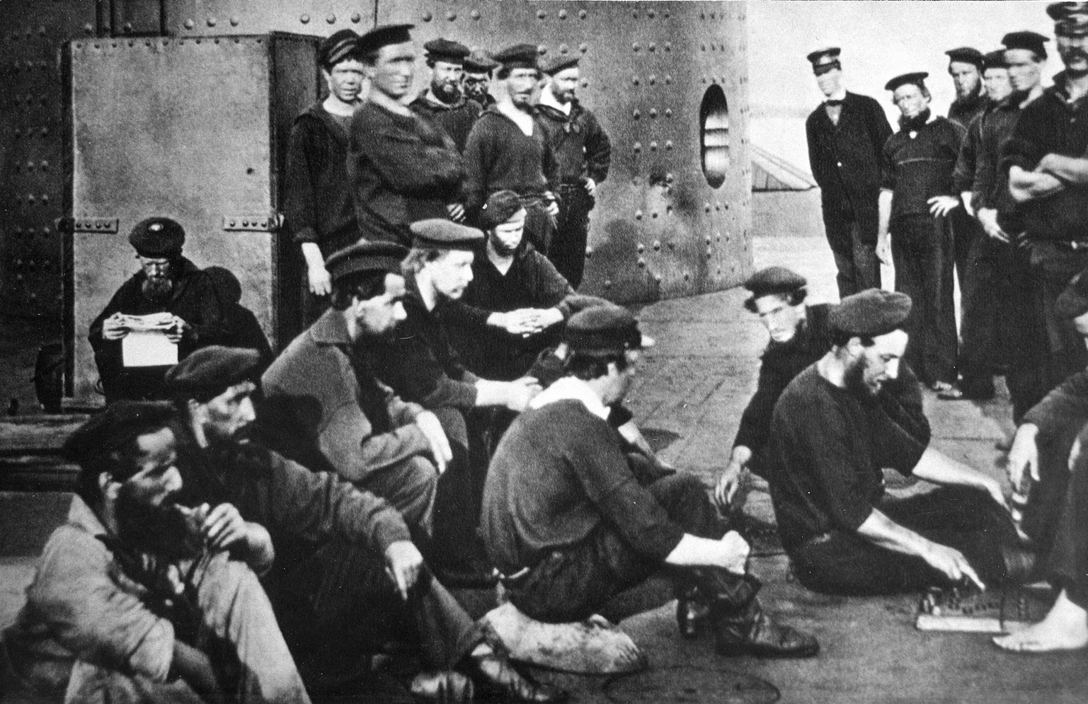 Union sailors relax on the flat deck of the Monitor after the battle. The damage inflicted by the CSS Virginia can be seen in the Monitor’s dented turret. 