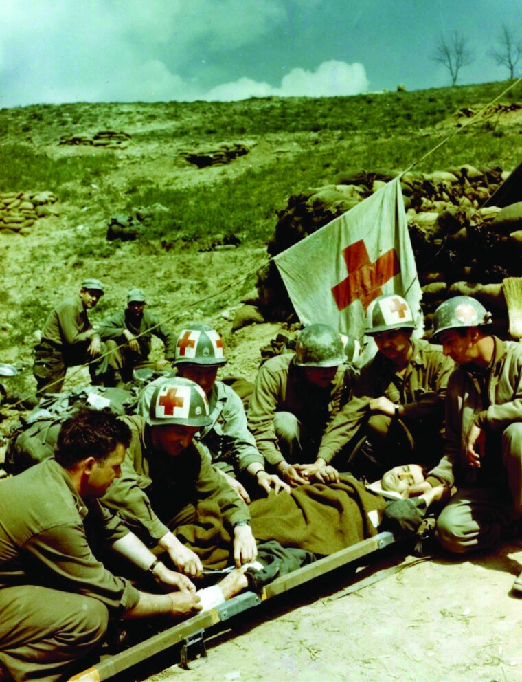 A prisoner is given medical care by medics of the U.S. 10th Mountain Division near Bologna.